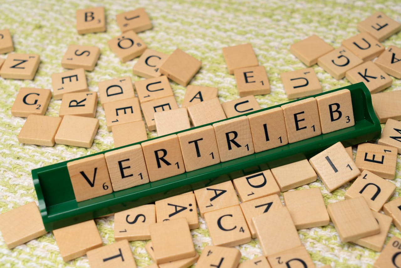 About Close-up of Scrabble tiles spelling 'Vertrieb', showcasing language learning and play.